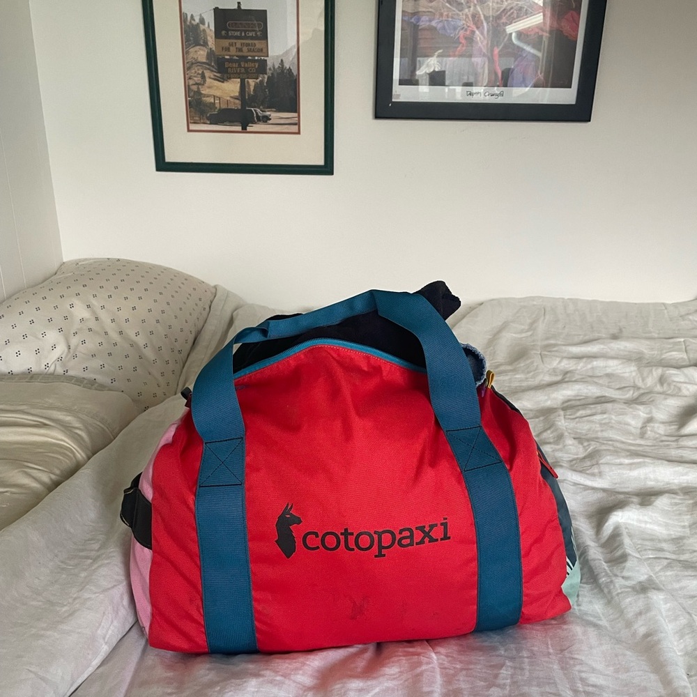 Cotopaxi Red Duffel Bag with Blue Straps